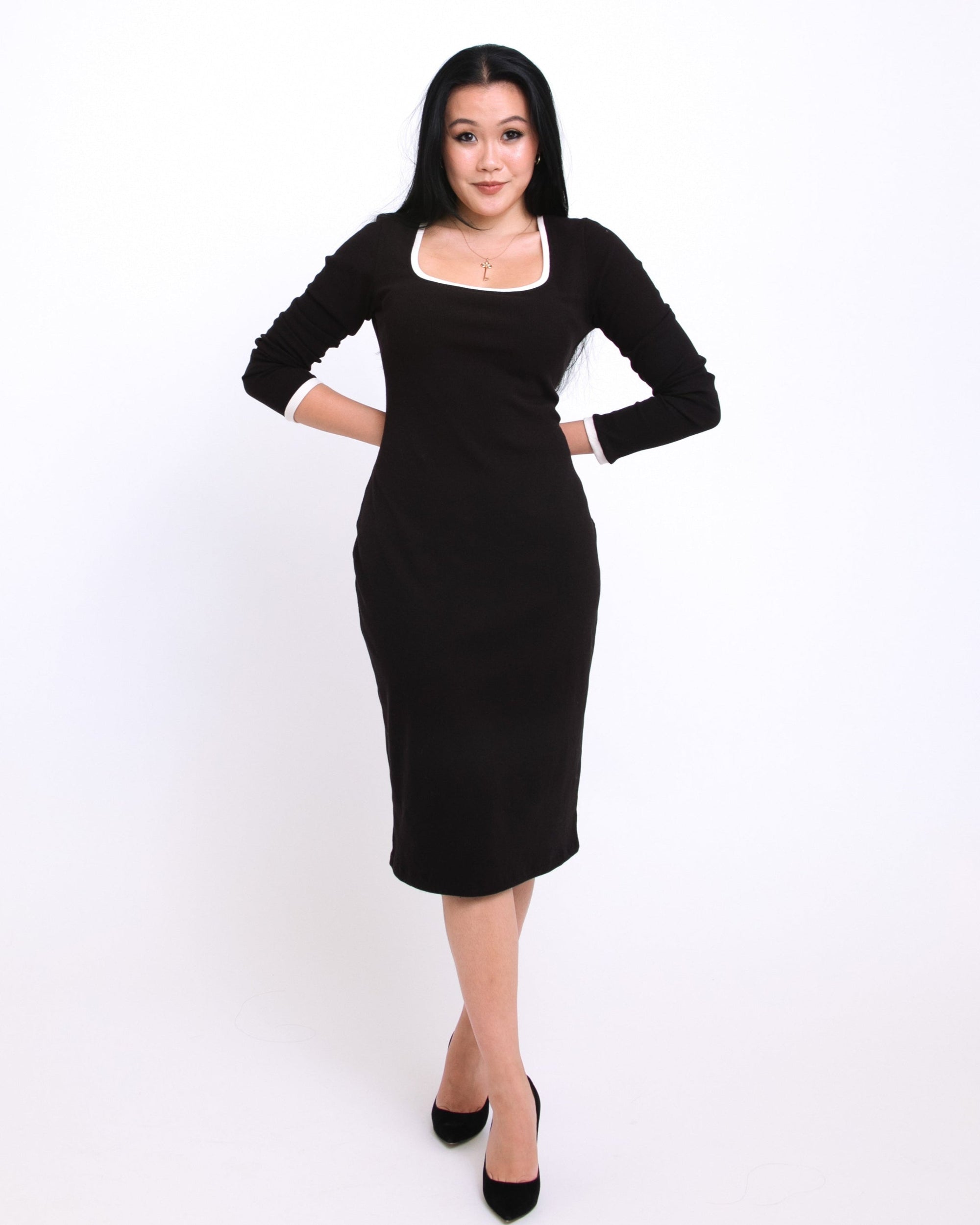 Woman wearing a black dress on a white background